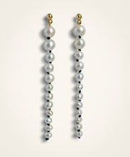 Load image into Gallery viewer, set of earrings. made of graduated white pearls with black knots inbetween them. They're suspended from small domed gold studs. White freshwater pearls  •	Hand-knotted on black silk thread with an 18 ct gold plated silver stud attachment •	Length 8 cm •	Handmade in Australia