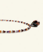 Load image into Gallery viewer, The Artemisia multi gem necklace is threaded with colour and light. Crystals such as aventurine, crystal, garnet, amethyst, iolite and smokey quartz make up a string vibrating light and protection. The finishing drop is a peacock baroque pearl.
