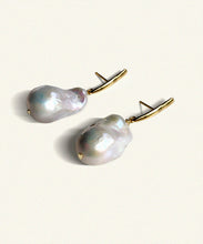 Load image into Gallery viewer, Suspended from an elongated vertical gold bar hangs an unruly pearl. Lustrous and perfectly imperfect, the unique distinctiveness of baroque pearls is a beautiful reminder that we ourselves are just that.   Named after the Queen Boudicca, who found the warrior within and created her own legend..     Made from juicy natural white baroque pearls   the slim elegant fitting is 18 ct gold plated silver. Each pearl is unique. Handmade. Bassike.