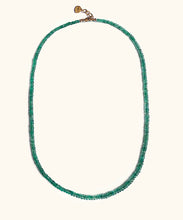 Load image into Gallery viewer, A emerald necklace on white background. With gold lock and chain. The emerald is ruled by Venus, the Goddess of love and beauty, while green activates the heart Chakra. This necklace is the the ultimate confession of self love.