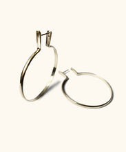 Load image into Gallery viewer, Large sterling silver hoops with a lip to cover your ear piercing. The hoops look substantial not flimsy, they are crafted from one piece of silver
