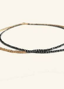 Made from hematite and golden rings, the Hypatia necklace is slender, strong and plays with proportions by simple asymmetry. It can be worn wrapped or long. the combination of gold and dark grey makes this an elegant statement for day and night