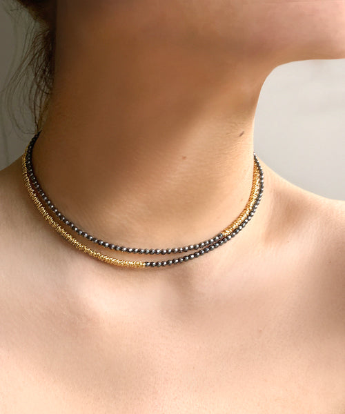 Made from hematite and golden rings, the Hypatia necklace is slender, strong and plays with proportions by simple asymmetry. It can be worn wrapped or long. the combination of gold and dark grey makes this an elegant statement for day and night