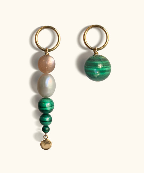 SOLSTICE ASYMMETRIC EARRINGS With its remarkable green colour and distinctive concentric  rings, malachite has a regal and mesmerising appearance.   Orbs of green malachite, pink moonstone and white pearl  make up the Solstice Asymmetric Earrings, creating a fresh  colourful expression for summer.